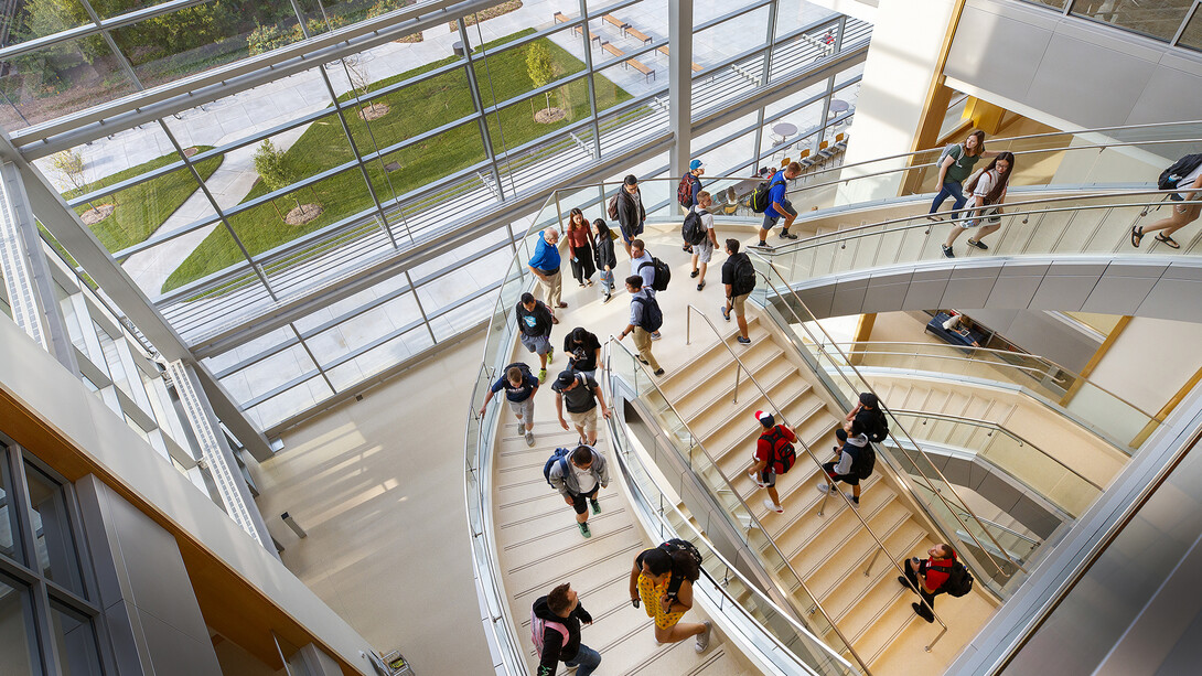 Students walk up the south staircase toward the third floor of the College of Business' new Howard L. Hawks Hall on the opening day of the fall semester.