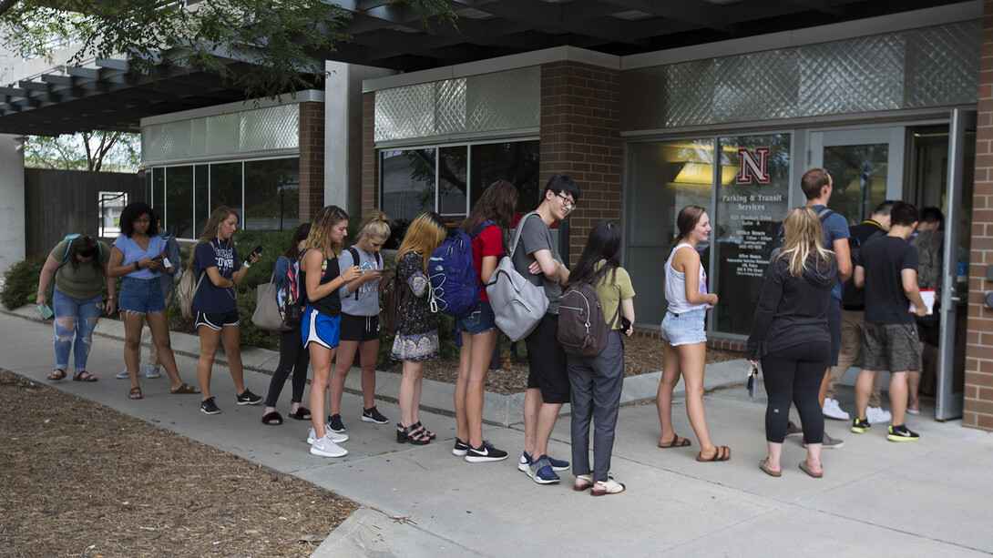 Students stand in line outside Nebraska's parking and transit services office prior to the eclipse.