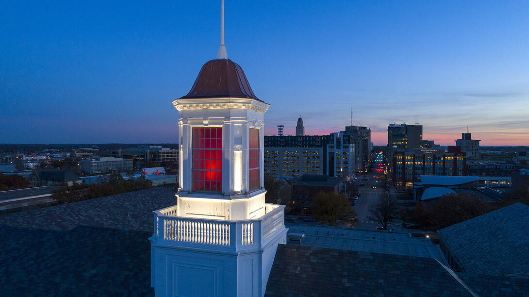 The sun sets as Nebraska's Love Library cupola glows over downtown Lincoln. Chancellor Ronnie Green announced Dec. 5 that the university will not be moving forward with additional proposed budget cuts.