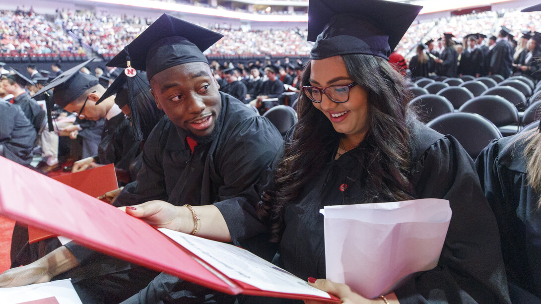 Nasan Altwal examines her diploma as she and Feedom Akinmoladun discuss graduation during commencement exercises on May 5. In case you missed it, Nebraska conferred a record 3,221 degrees during ceremonies on May 4 and 5.