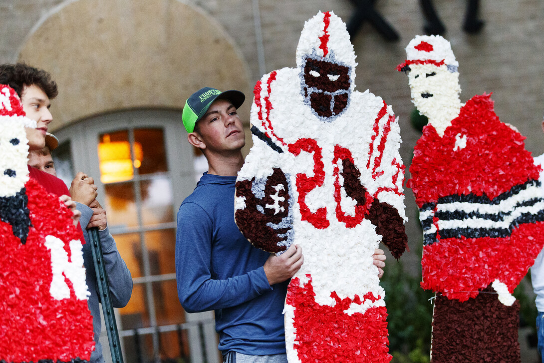 A Nebraska student helps build a homecoming yard display on Sept. 28.