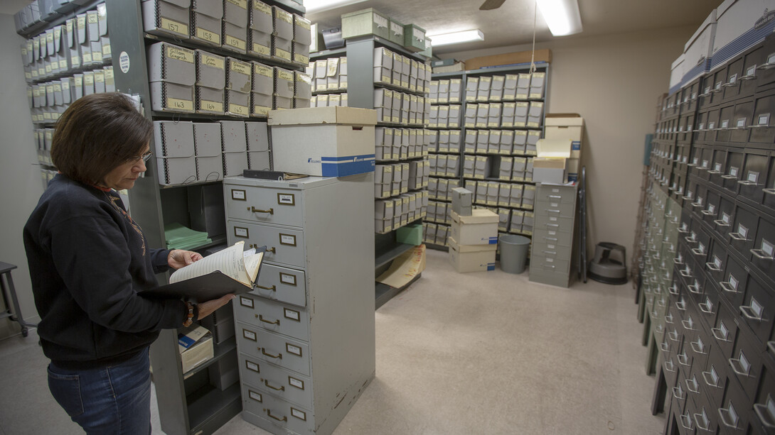 Cathy Urban searches through files in the student records vault. The university is digitizing all files in the vault, which include student records from 1955 to 1986. All student records before 1955 have been recorded on microfiche, while those after 1986 have always been available via computer files.