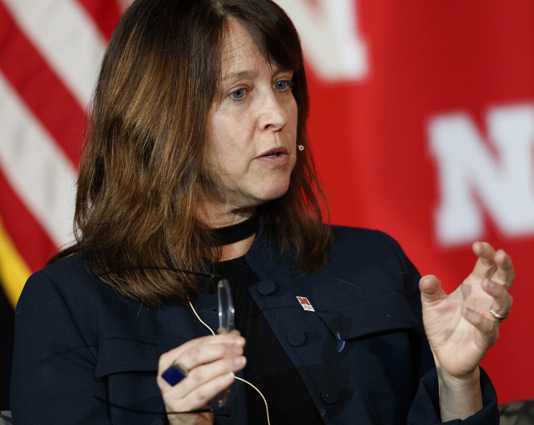 Patrice McMahon, director and chair of the University Honors program, helps guide the panel discussion between Sen. Sasse and Husker students.