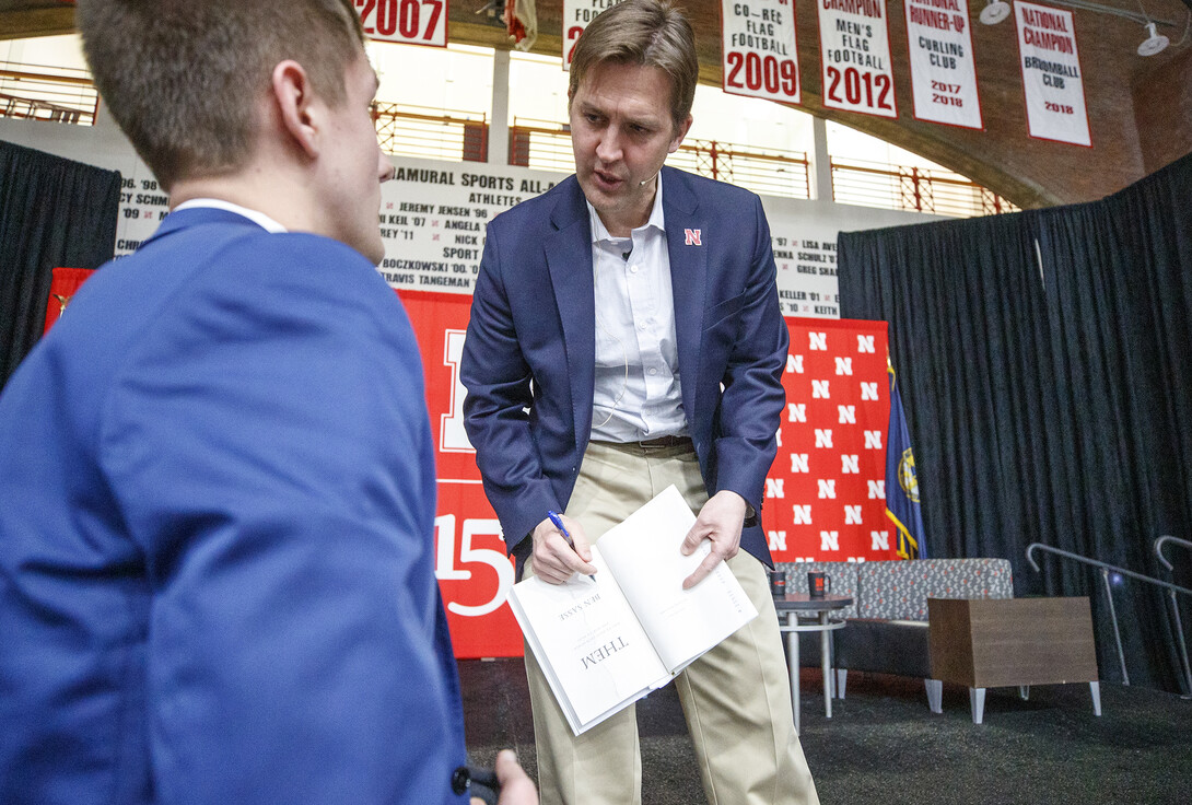 Sen. Ben Sasse autographs a copy of his book for Garrett Streeks, junior from Lincoln, after the Feb. 11 visit.