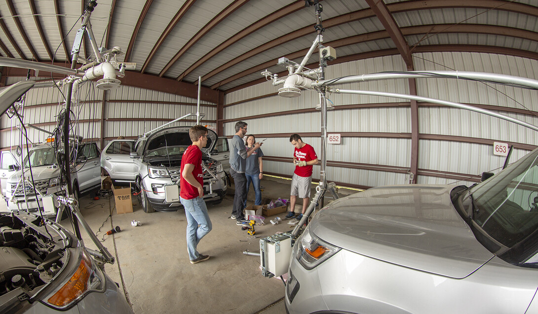 Nebraska's Adam Houston and student researchers discuss the mesonet vehicle builds and upgrades in a shed by the university motor pool. Nebraska students have customized four of the storm chase vehicles since 2015. Three will join the TORUS project this summer. The fourth was purchased for a Central Michigan University research project.