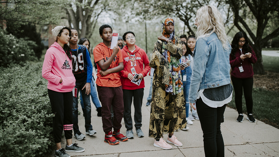 Nebraska's Morgan Mattly leads a group of Lexington middle schools students on a tour of campus on May 1.