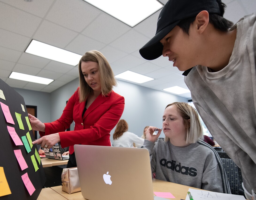 UNL professor interacting with students on a sustainability project