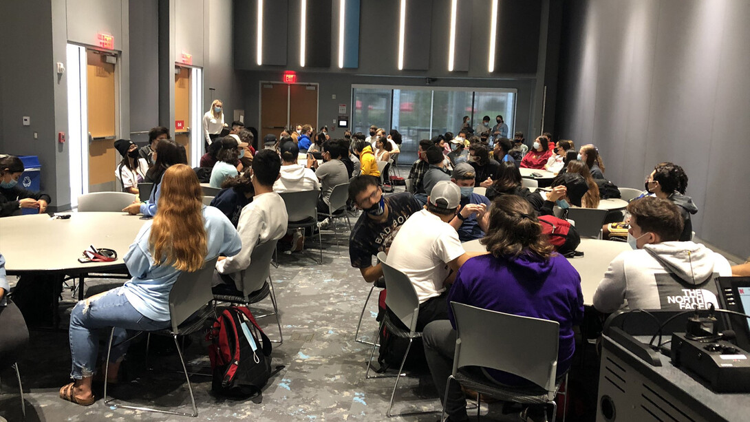 Students sitting at tables in Cather Dining Hall