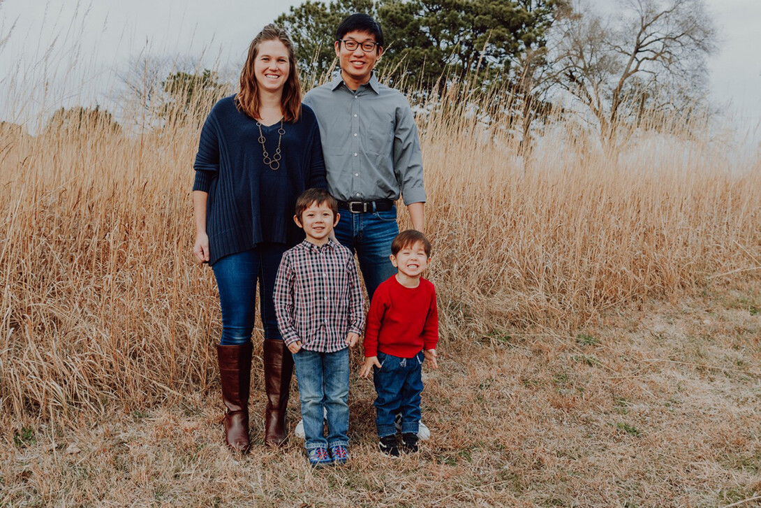 John Tessalee and his wife, Brittany, pose with their two sons for a family photo.