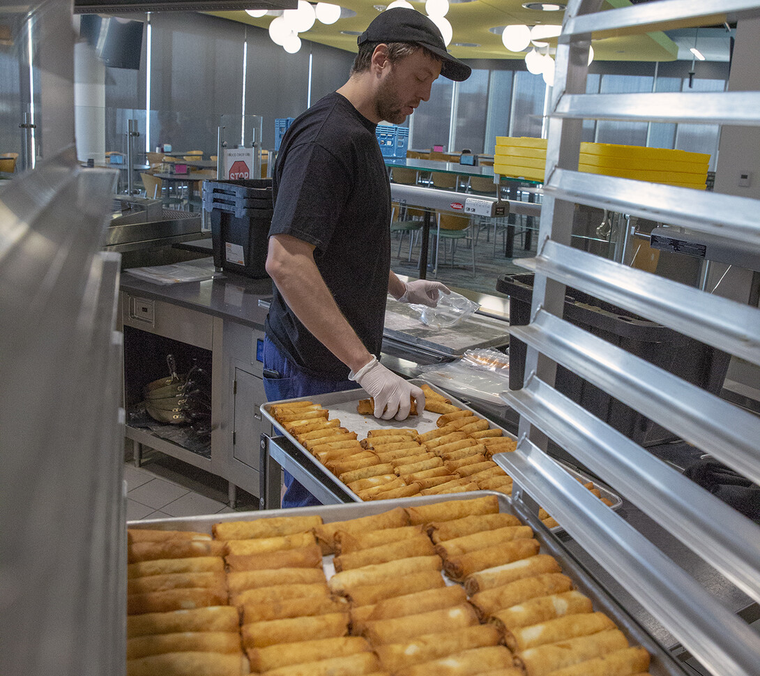 Cameron Gereau, a dining service team leader in the Cather Dining Center, packages the precooked egg rolls for freezing. The Cather team crafted some 5,500 egg rolls during the week of Jan. 6. Of that total, 5,000 will be served in the Cather Dining Center, while the other 500 were created for a retirement celebration.