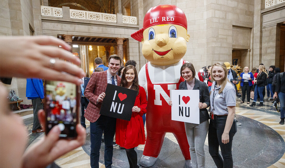 Lil' Red poses with UNL students in the rotunda. NU Advocacy Day at the Capitol. March 10, 2020. 