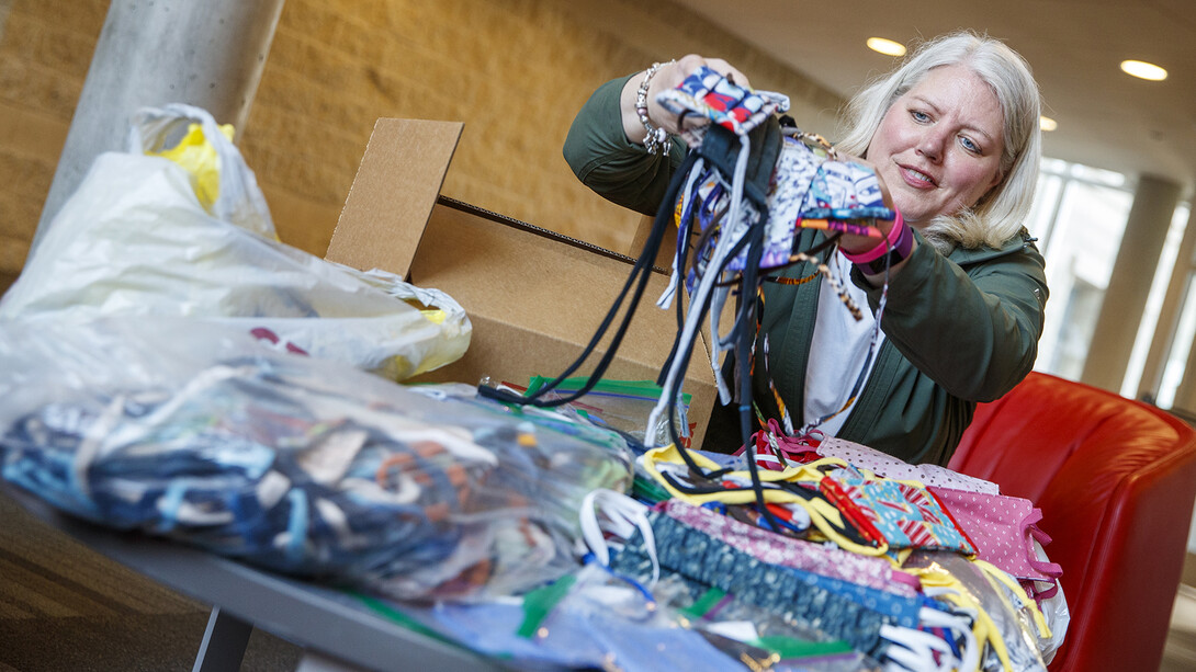 Veronica Riepe counts donated cloth masks before they're distributed to the nearly 1,000 university employees who continue to work on campus.