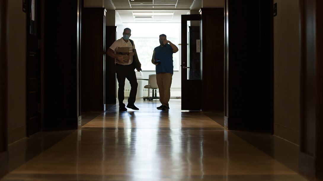 Jack Dohrman (left) and Shawn Languis move to the next task as they measure rooms in Avery Hall earlier this month.