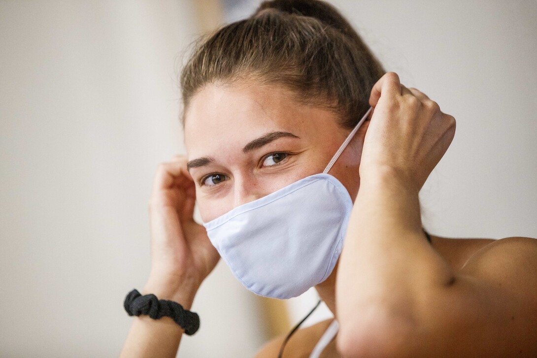 Olivia Boldt, senior from Madison, South Dakota, puts on her mask before going to work out. June 15, 2020. Photo by Craig Chandler / University Communication