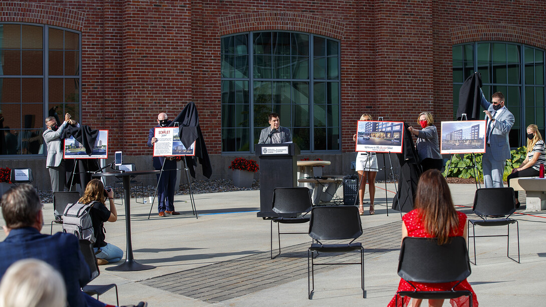 Campus and project leaders reveal the name of The Scarlet Hotel as Clint Runge talks during the Aug. 18 event at Nebraska Innovation Campus.