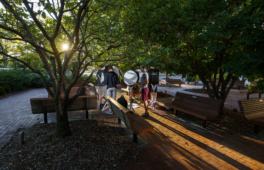 The bass line offers up a sunrise serenade under the trees outside the Lied Center for Performing Arts.