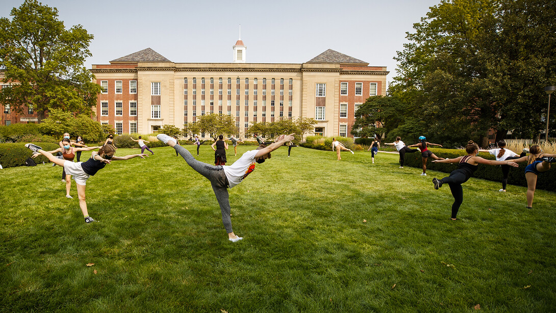Students in a modern dance class led by Susan Ourada practice on the green space south of Love Library on Sept. 17. Support from donors has helped remove the university’s dance program from a list of proposed budget reductions.