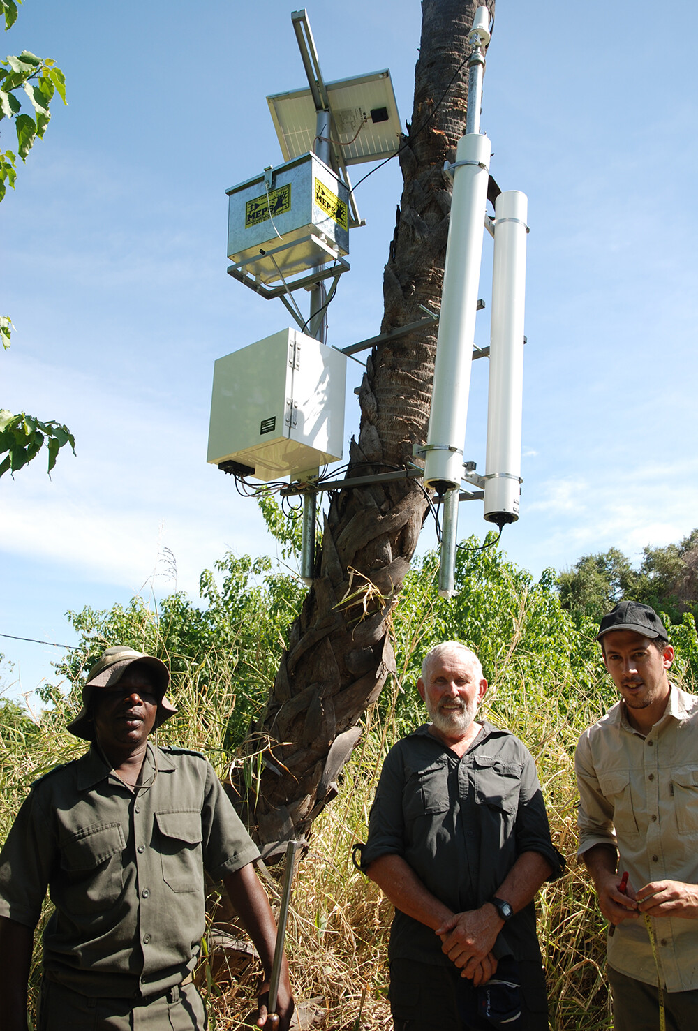 A cosmic ray detector, which is being used in a study that includes UNL's Trenton Franz, is mounted to a tree in South America's Mapungubwe National Park. Pictured (from left) is Steven Khoza, field technician and range for the South African National Parks; Colin Everson, hydrometeorologist and project principal investigator on the project; and Bruce Scott-Shaw, doctoral student at the University of KwaZulu-Natal. 