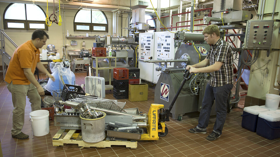 Steve Weier (left) and Russell Parde prepare equipment in a food science and technology pilot plant for the move to Nebraska Innovation Campus. The department will move over the next three weeks and open for classes in August.