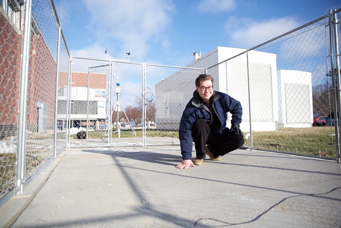 Chris Tuan, professor of civil engineering at the University of Nebraska-Lincoln, stands on a slab of conductive concrete that can carry enough electrical current to melt ice during winter storms. Tuan is working with the Federal Aviation Administration and U.S. Strategic Command on multiple applications for his patented concrete mixture.