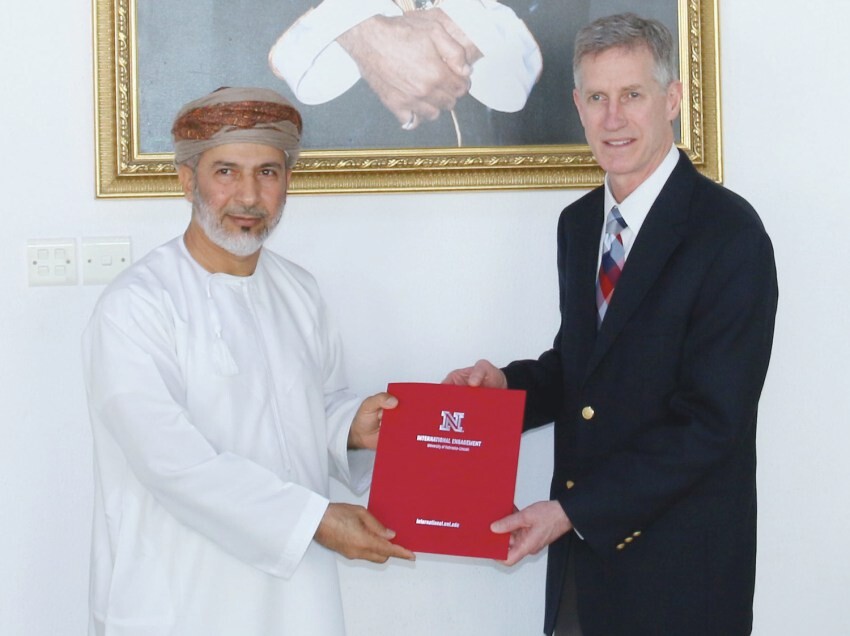 Abdulkarim Sultan Al Mughairi (left), dean of Oman Tourism College; and Timothy Carr; chair of UNL's Department of Nutrition and Health Sciences; hold a memorandum of understanding to facilitate academic collaboration between the institutions. 