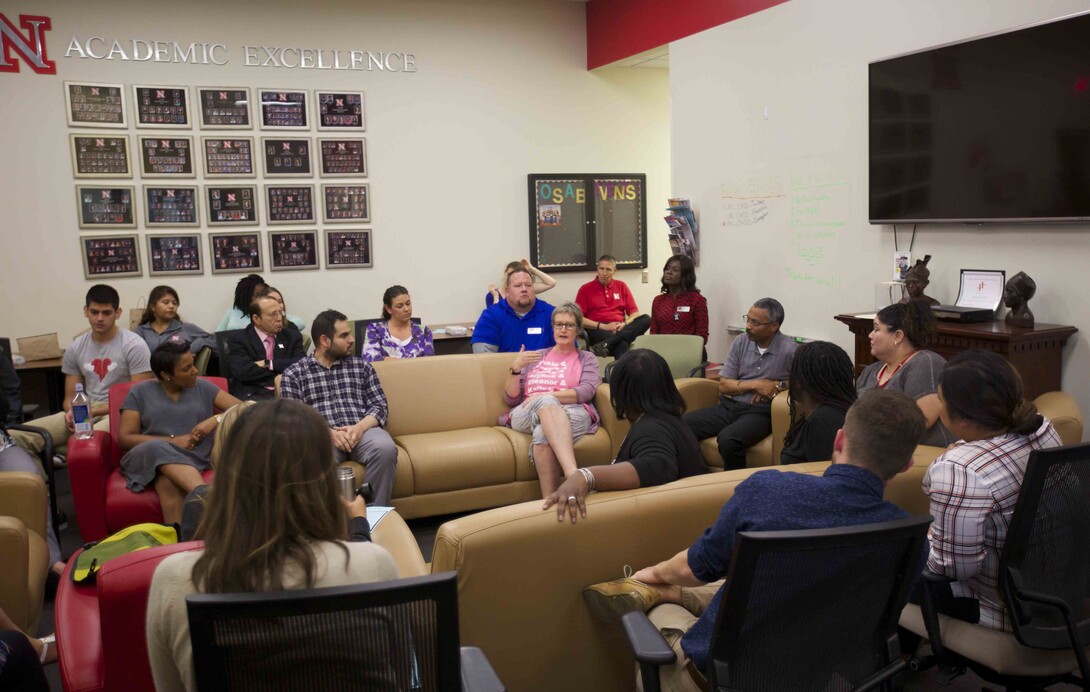 Christina Brantner (center, pink shirt), associate professor of modern languages and literatures, offers her thoughts during the "Dish It Up" conversation.