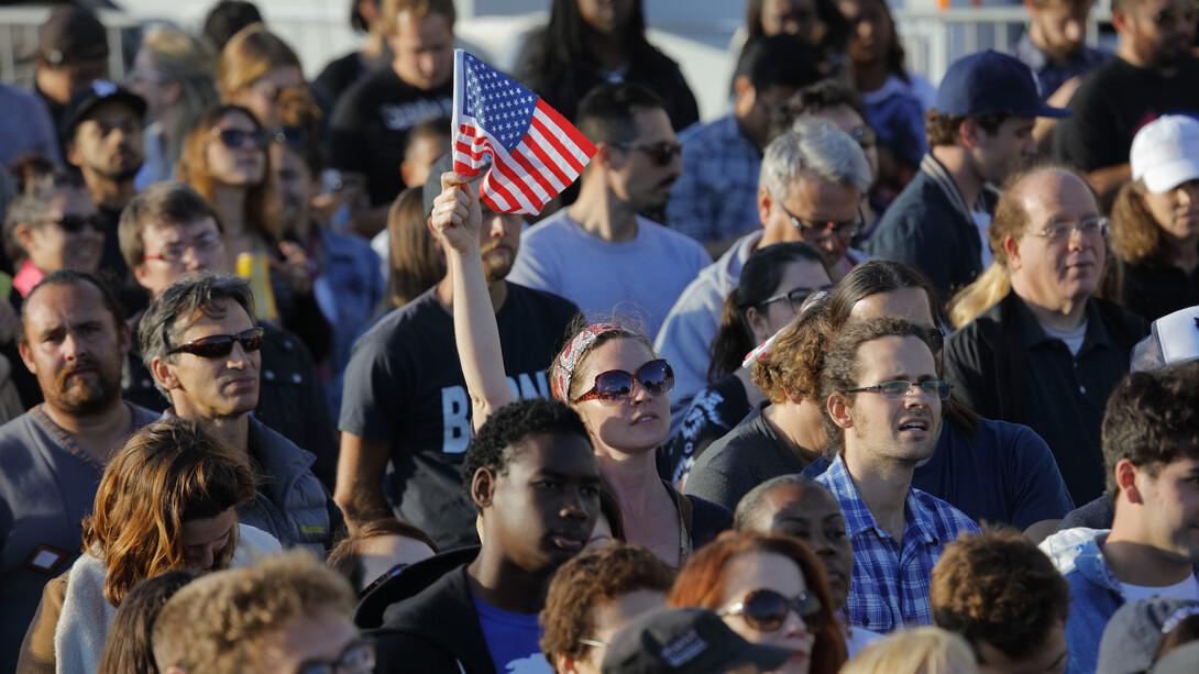 Woman holding an American flag during a 2016 presidential election rally