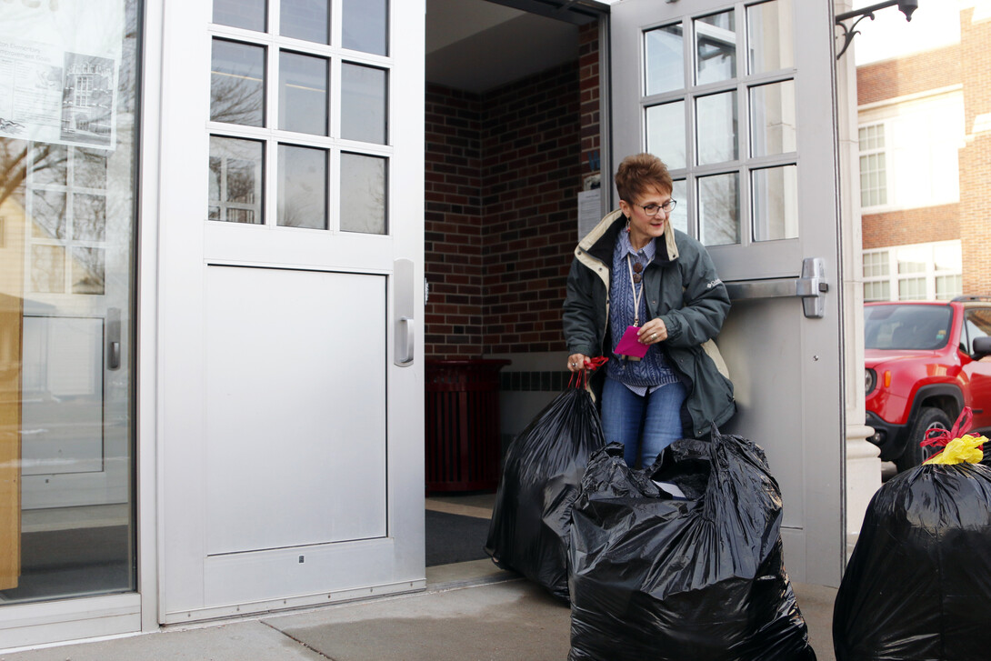 Linda Kern, of Clinton Elementary School, helps bring in the donations from the SNR Caring for Clinton Drive on Tuesday, Dec. 11, at the school on 29th and Holdrege streets.