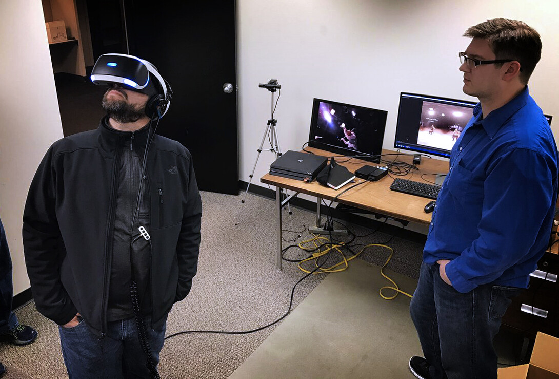  Adam Wagler, assistant professor of advertising, reviews 360-degree video with David Koehn, NET producer, as part of the collaboration to continue work in virtual reality research.