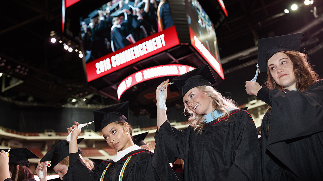 Virginia Hill (left), Master of Arts in political science; Hillary Hotz (center), Master of Arts in educational administration; and Melissa LaRosa (right), Master of Arts in educational psychology; move their tassels at the end of the graduate and professional degree ceremony Dec. 14 at Pinnacle Bank Arena.