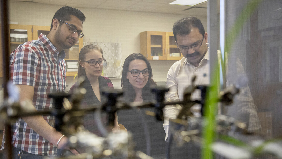 Graduate students (from left) Sajjan Grover, Mariana Sanchez and Karen Da Silva look at computer readings with Nebraska entomologist Joe Louis.