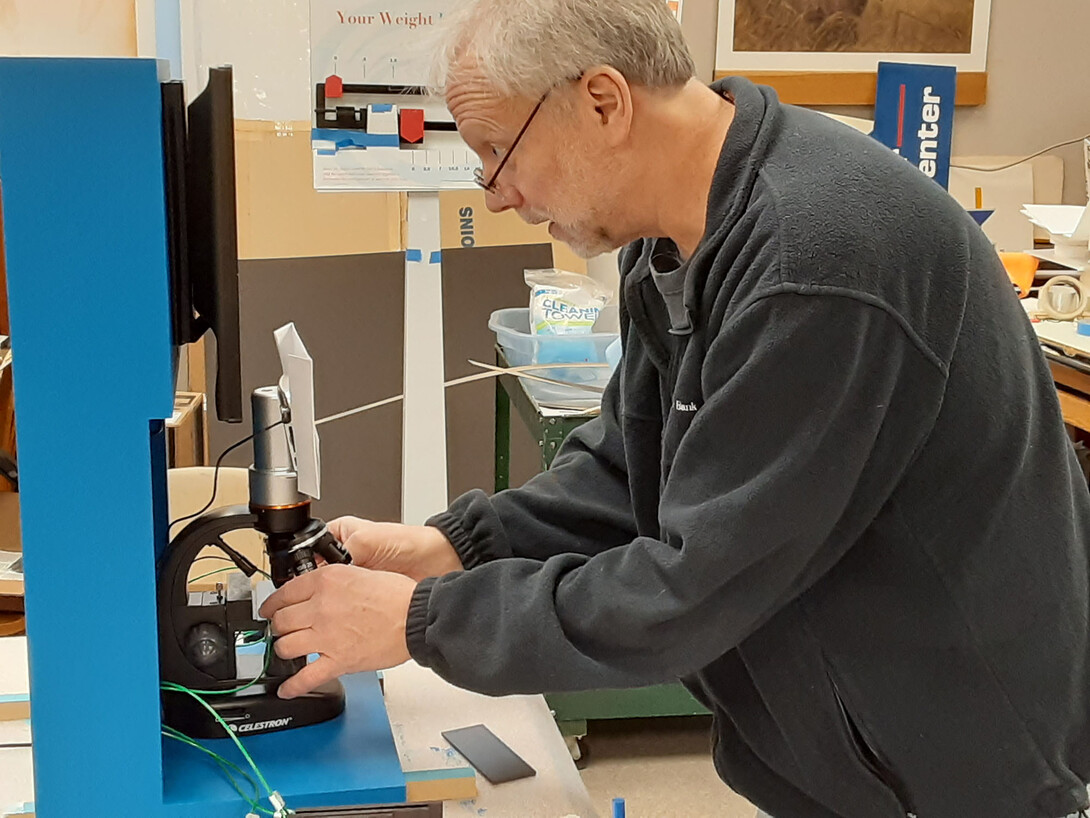 Joel Nielson, graphics specialist and project coordinator at the University of Nebraska State Museum, constructs a microscopic interactive for “H2O Today.” The exhibition will blend information and hands-on experiences to tell the story of water globally and locally.