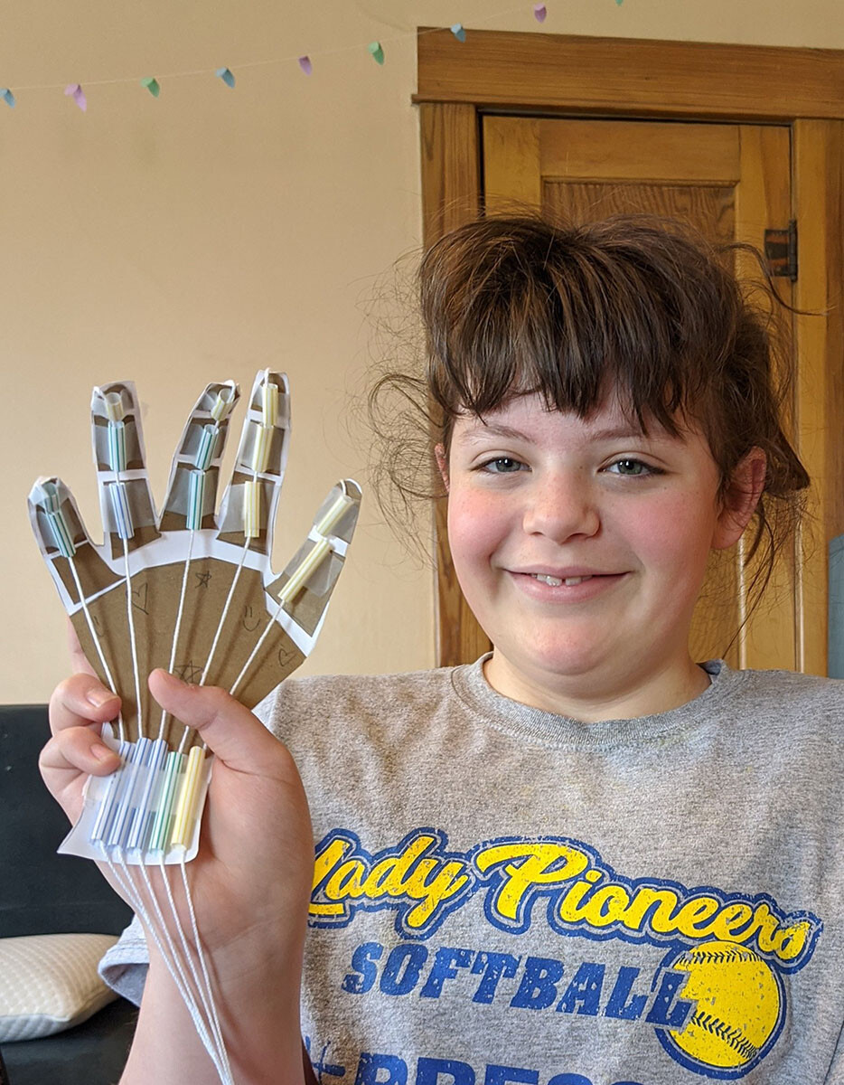A youth shows the robot hand she created during Nebraska 4-H’s Living Room Learning livestream March 17.