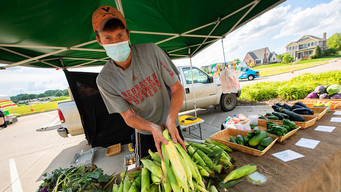 A vendors sells produce at the Fallbrook Farmers Market in northwest Lincoln on July 23. A new $1 million, three-year grant will allow Nebraska Extension to expand the Double Up Food Bucks program to more grocery stores and farmers markets across the state.