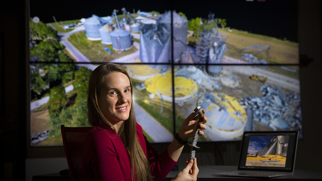 Christine Wittich compares a damaged anchor from the field with three-dimensional point cloud data of the structure.