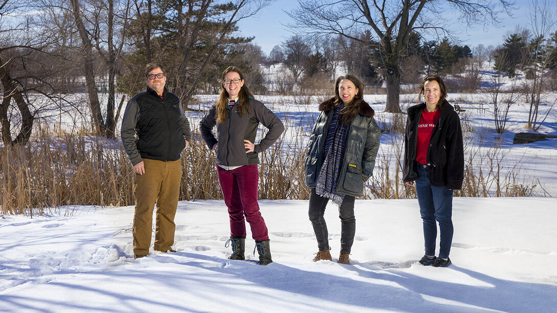 Husker researchers Steven Thomas, Jessica Corman, Katie Anania and Jennifer Clarke are leading a $6 million multi-institutional project to build a database that will enable scientists to track the changing ecology of waterways across the U.S. Pictured at Holmes Lake in Lincoln, the Nebraska team members were photographed individually to create a composite photo.