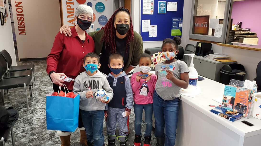 Susan Weller, director of the University of Nebraska State Museum-Morrill Hall (back row, left), visits the Malone Community Center to deliver free passes to the museum. Also pictured are Mismiki Montgomery, director of youth programs at the Malone Center (back row, right), and (front row, from left) Joseph Alvarez, Endy Alvarez, Saniyah Sims and Shylah Divers.