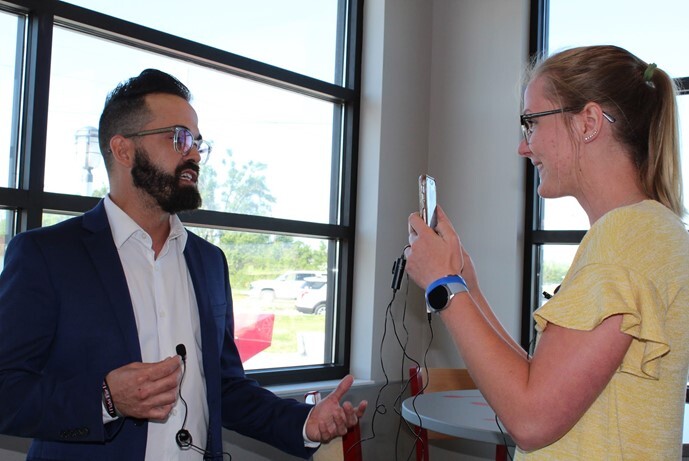 Rural Fellow Lydia Behnk (right) interviews General Manager Sam Nelson at the grand opening of the new Dairy Queen in Schuyler.