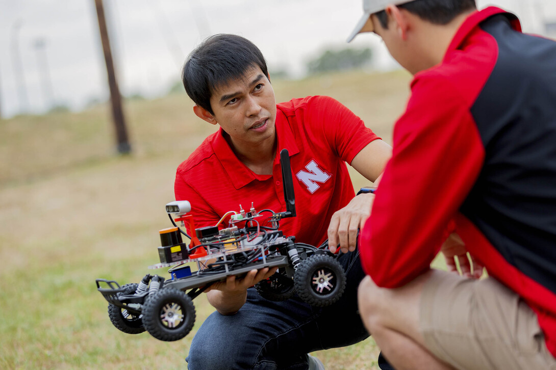 Hoang-Dung Tran, assistant professor of computer science and engineering, discusses a programmable vehicle at the NIMBUS lab on Nebraska Innovation Campus on Oct. 6. 