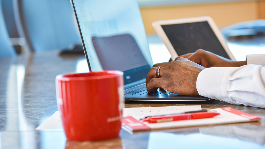 Hands resting on laptop keyboard