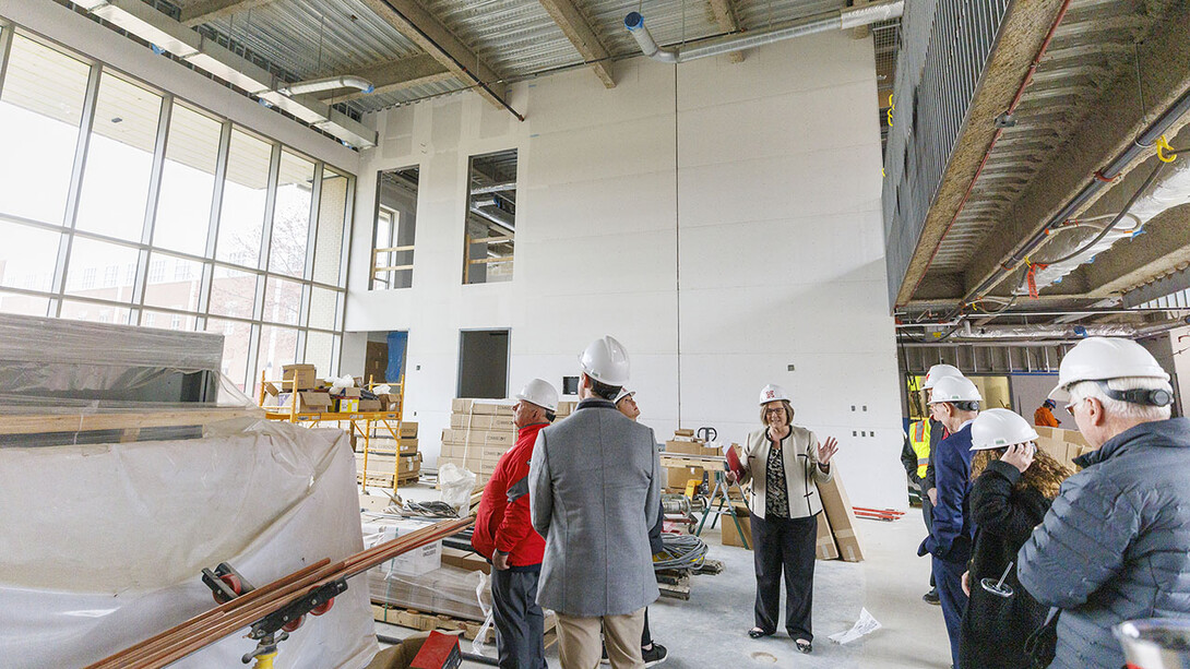 Sherri Jones, dean of education and human sciences, describes the open space called the “living room” under construction in Carolyn Pope Edwards Hall during a Board of Regents tour April 7.