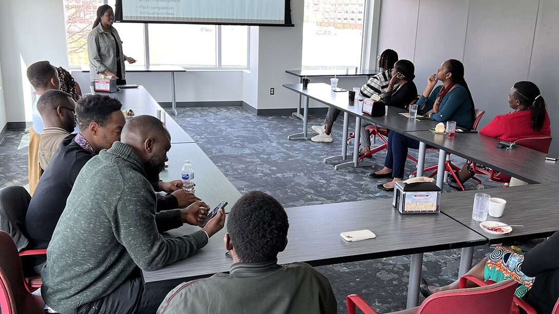 Rwandan students at tables, watching presentation during CUSP Career Expo