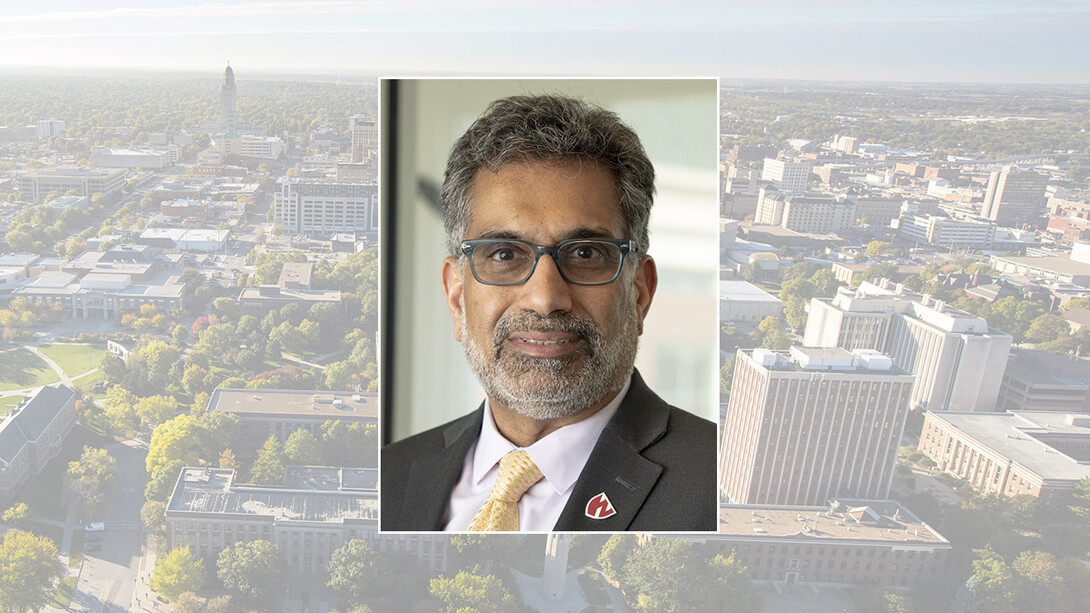 A color portrait of Dr. Ali S. Khan on a color campus background