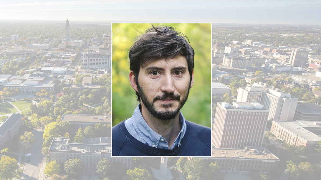 Color portrait of Tyler Riewer on color campus background