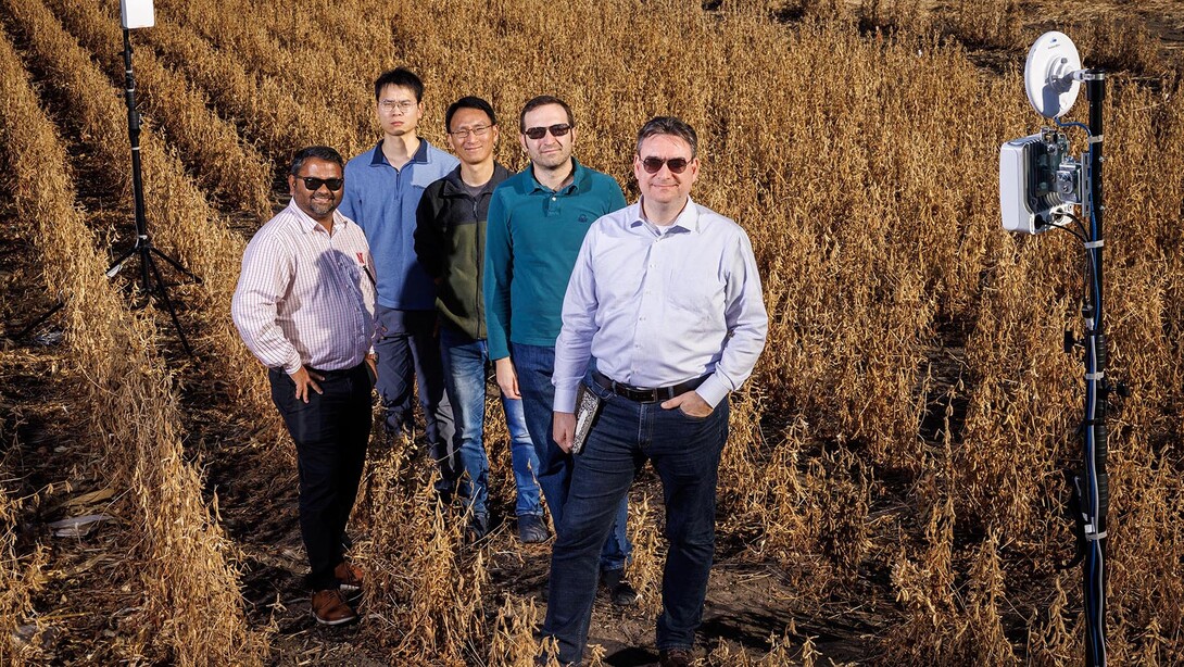 Members of the Field-Nets research team pose in a soybean field on East Campus with their millimeter wave radios with phased-array antennas. The researchers (from left) are Santosh Pitla, Qiang Liu, Yufeng Ge, Christos Argyropoulos and Mehmet Can Vuran.