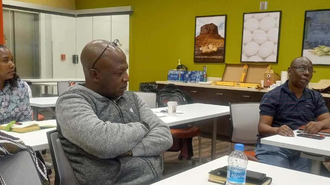 Wilton Mbinda (right), a biotechnologist with Pwani University in Kenya, offers observations during a briefing session on plant pathology at Nebraska’s Food Innovation Center. Listening are (from left) Zena Mchomvu, an agricultural economics specialist from Tanzania, and Charles Mgeni, with the Sokoine University of Agriculture in Tanzania.