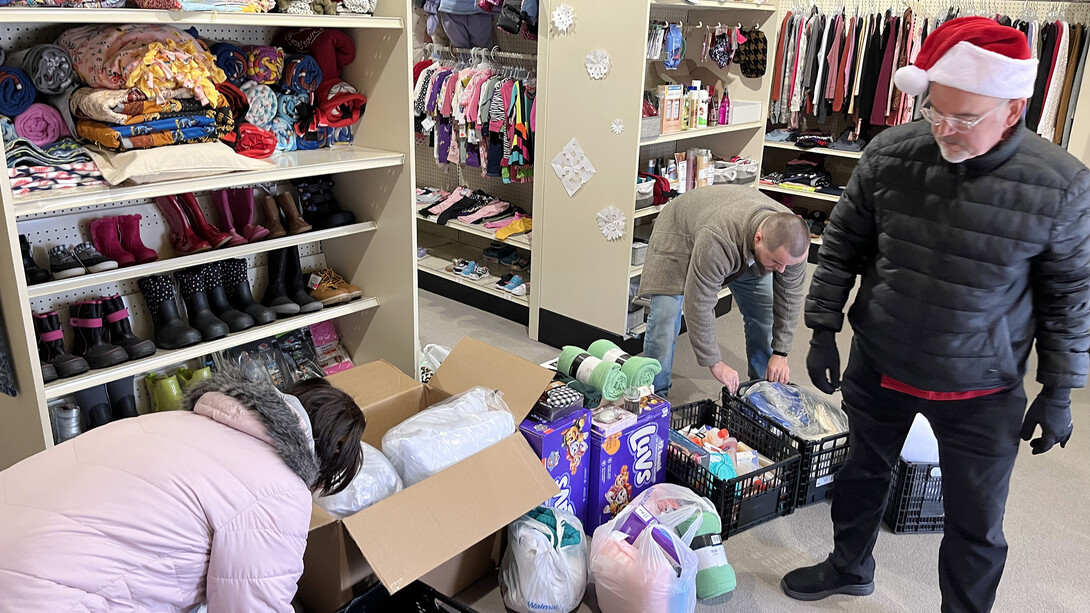 Paul Brown (right) and Tina Pham (left) drop off donations Dec. 16 at the Foster Care Closet. 