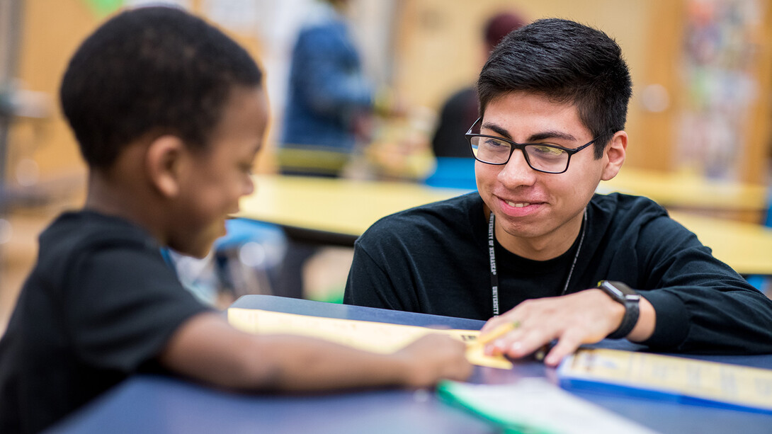 Nebraska's Carlos Ortega works with a student at the Community Learning Center at Lincoln's McPhee Elementary School.