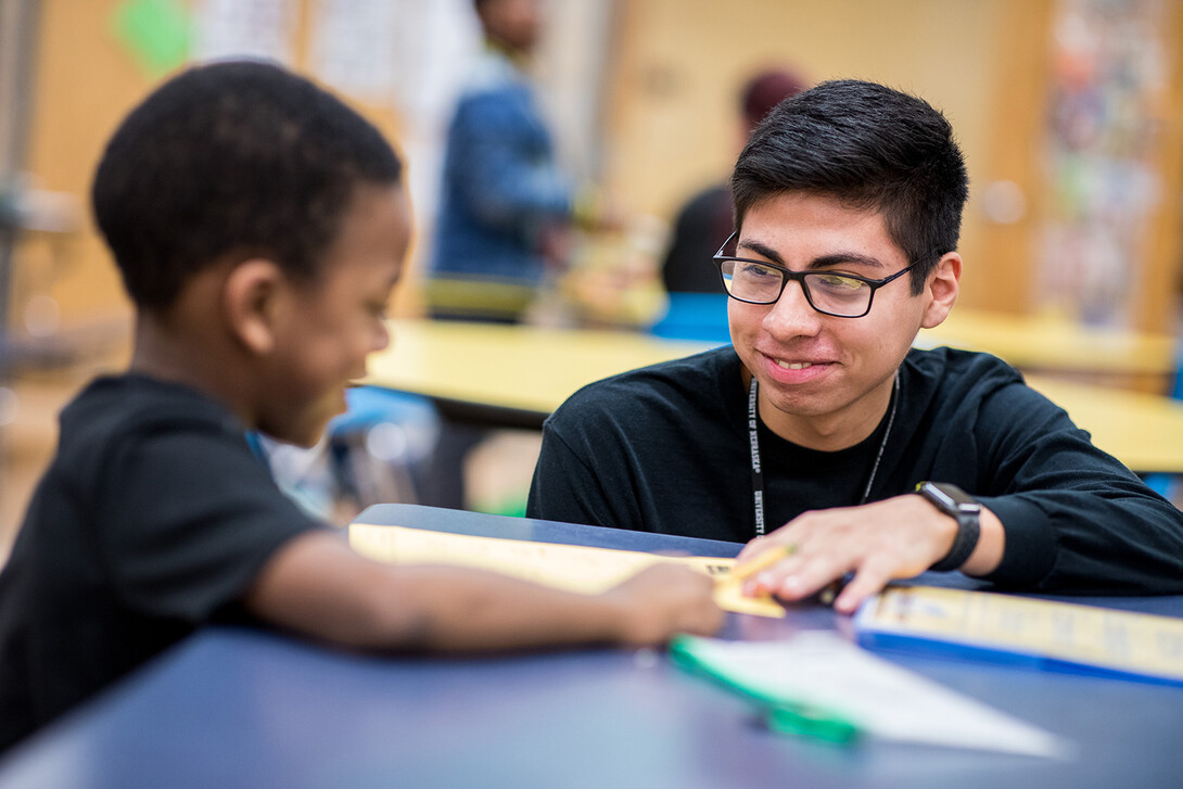 Nebraska's Carlos Ortega works with a student at the Community Learning Center at Lincoln's McPhee Elementary School.