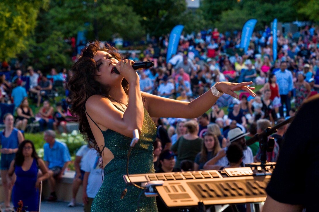 Alexis Arai sings into a microphone.